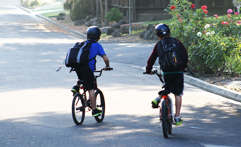 Boys riding bikes to school