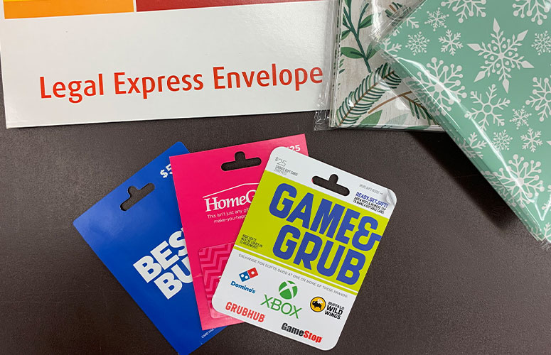 gift cards on the counter at staples with shipping supplies