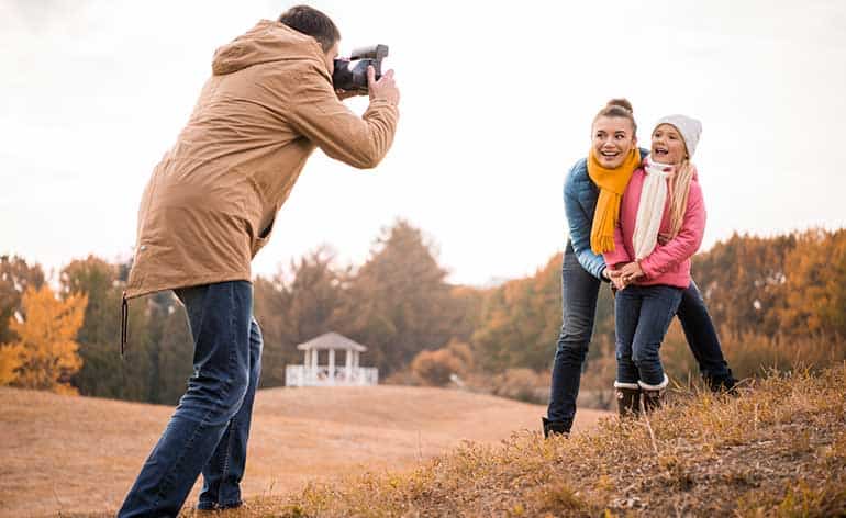 man taking a picture of the family