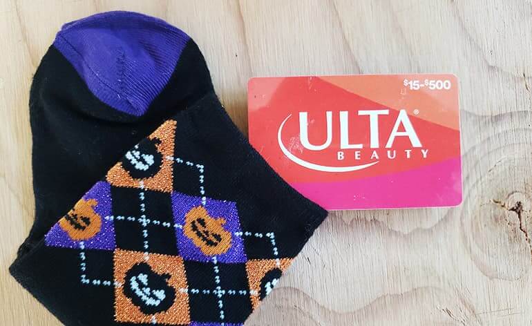 A gift card in a pair of Halloween socks