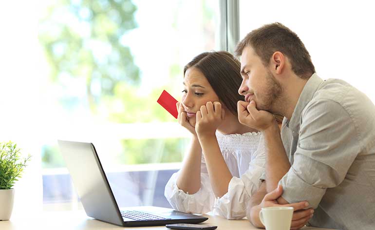 couple waiting for card to work on computer