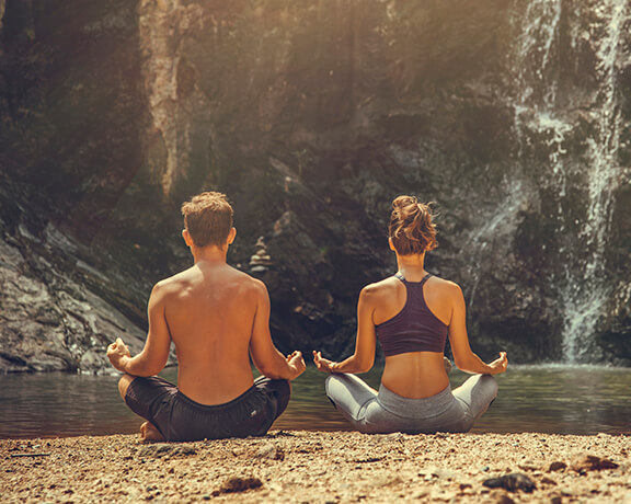 couple doing yoga outside