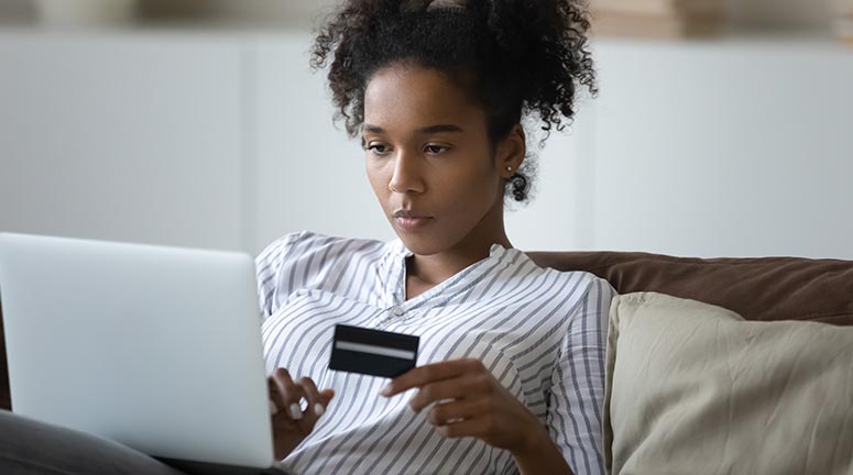 woman entering gift card number into computer