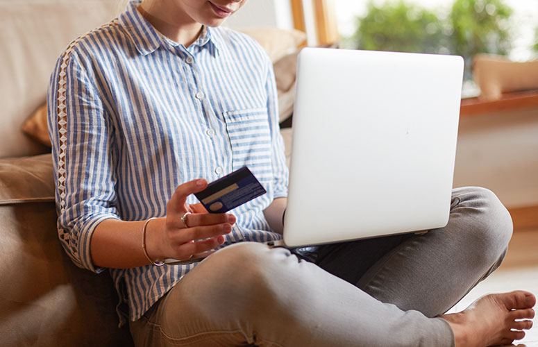 woman shopping online with gift card